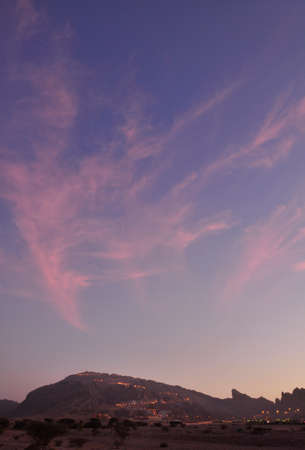 The skies above Jebal Hafeet. A colourful sky above the peaks of the Hajar Mountains, near Al Ain, UAE, part of the Hajar rangeの写真素材