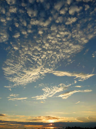Cloudy skies.  Fluffy white clouds against this blue sky over the river Mekong in Vietnamの写真素材