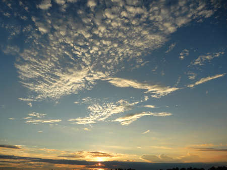 Cloudy skies.  Fluffy white clouds against this blue sky over the river Mekong in Vietnamの写真素材