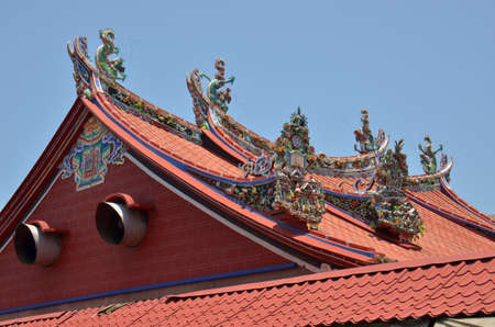 Roof decor. Colourful carvings adorn the roof of this temple in the centre of Georgetown, Malaysiaの写真素材