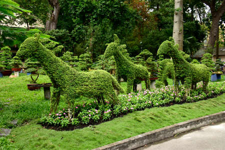 Topiary. Artistically shaped greenery displayed here at Saigon Zoo in Ho Chi Minh City, Vietnamのeditorial素材