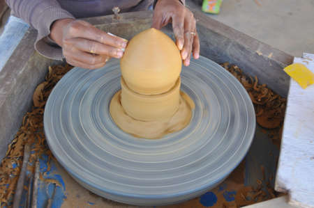 Using this wheel to make pottery items like incense burners here in Siem Reap, Cambodiaの写真素材