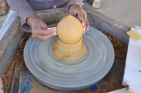 Using this wheel to make pottery items like incense burners here in Siem Reap, Cambodiaの写真素材