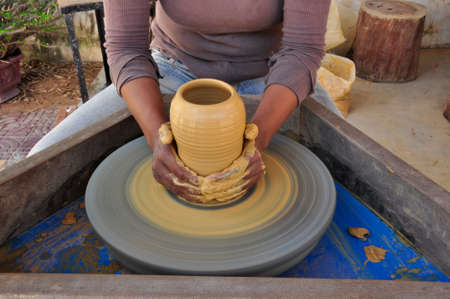 Using this wheel to make pottery items like incense burners here in Siem Reap, Cambodiaの写真素材