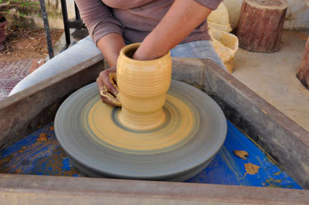 Using this wheel to make pottery items like incense burners here in Siem Reap, Cambodiaの写真素材