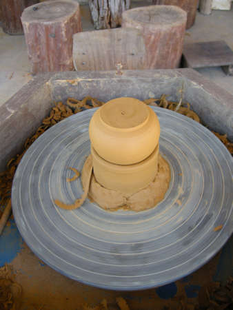 Using this wheel to make pottery items like incense burners here in Siem Reap, Cambodiaの写真素材