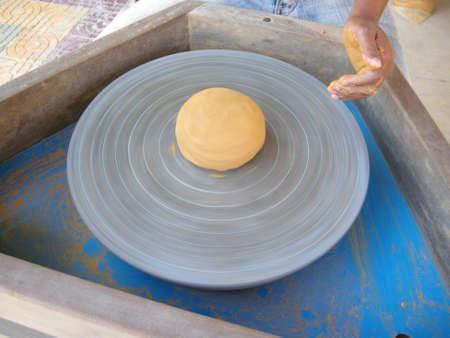 Using this wheel to make pottery items like incense burners here in Siem Reap, Cambodiaの写真素材