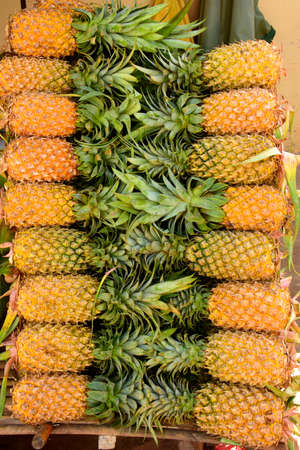 Pineapple (Ananas comosus).Produce on display and for sale on this fruits and vegetable market in Pnom Penn, Cambodiaの写真素材
