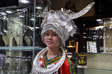 Chinese girl in Ceremonial costume. Wearing this ceremonial outfit which comes from South Eastern China, here in Cheng Du, Chinaのeditorial素材