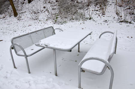 Covered in snow, this picnic table was found in a highway rest stop in Germanyの写真素材