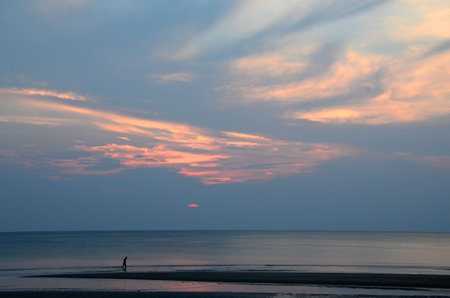 The sunrise colouring up the sky here in early morning on the western shore of the Gulf of Thailandの写真素材