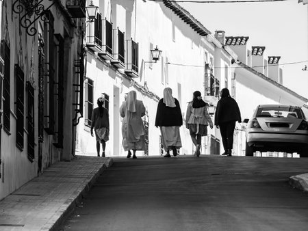 View of unknowns people walking in the streets of Carmona in the afternoon