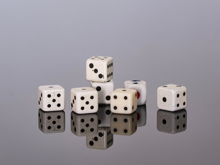 dice on a black reflective surface with reflection, closeup of photo