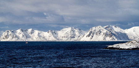 Beautiful winter landscape of snow-capped mountains and the sea