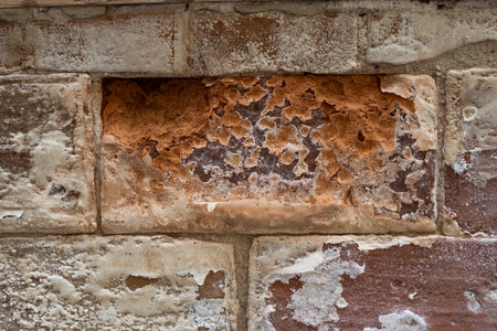 Old brick wall with plaster and peeling paint. Abstract background.の写真素材