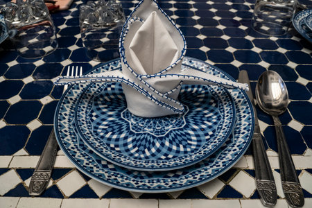 Table setting with cutlery and napkin in blue and whiteの写真素材