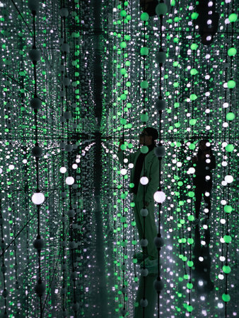 A man in a green suit looks at the lights.の写真素材