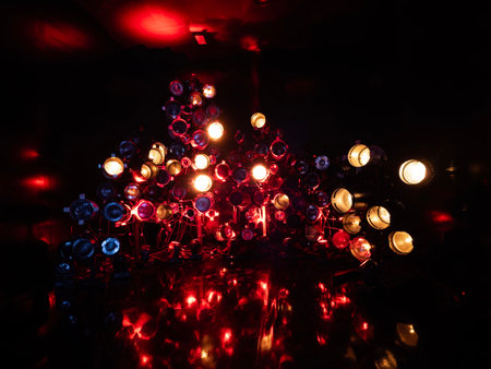 Christmas tree lights at night in a dark room with red and blue lights
