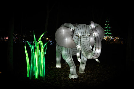 Elephant statue in the park at night with green led light.の写真素材