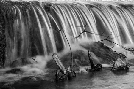 Long exposure of a waterfall on the river in winter. Toned.