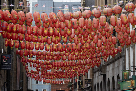 Traditional red lanterns hanging from the streets of London.の写真素材