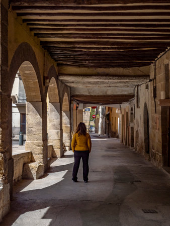 Woman walking through an alley in the old town of Salamanca, Spainの写真素材