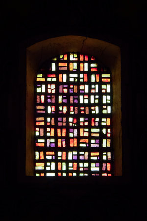 Colorful stained glass window in a church, closeup of photo