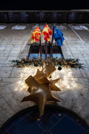 Christmas decoration on the roof of a building with a garland of lightsの写真素材