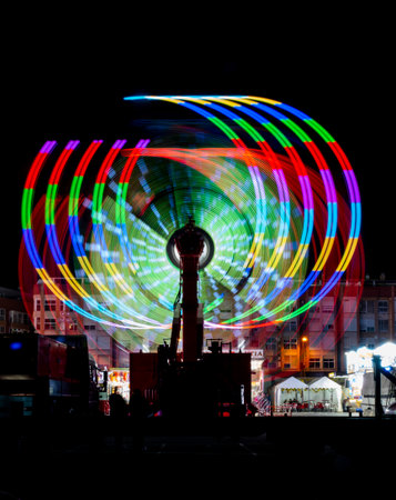 Colorful ferris wheel in the city at night. Long exposure.