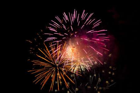 Colorful fireworks of various colors over night sky, celebration and anniversary concept