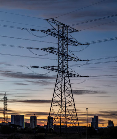 High-voltage power lines at sunset. Electricity pylons.