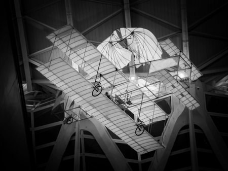 Black and white image of a structure hanging on the ceiling of a building.
