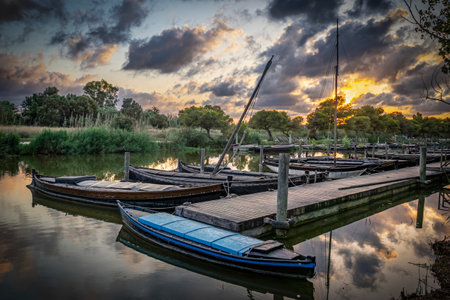 Fishing boats on the lake at sunset, Tuscany, Italyの写真素材