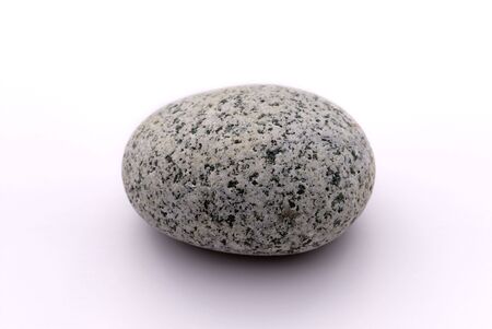 A black and white pebble on whiteの写真素材