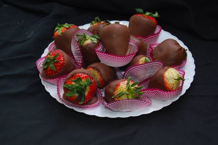 Chocolate covered strawberries on a plateの写真素材