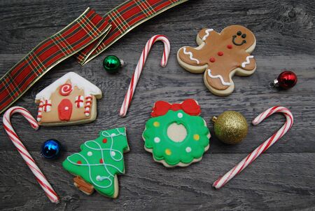 Christmas cookie flat lay with ornaments on woodの写真素材