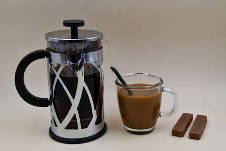 French Press pot of coffee, with a cup of coffee and a snackの写真素材
