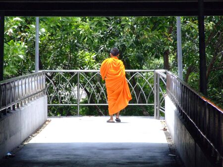 BANGKOK, THAILAND - AUGUST 18: Thai Buddhist monk crossing a bridge August 18, 2007 in Bangkok. のeditorial素材