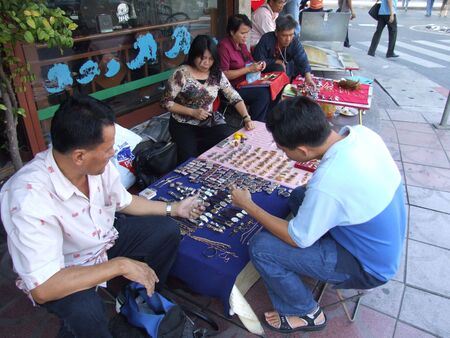 BANGKOK, THAILAND - JANUARY 20 : Thai people sell Buddhist ornaments and watches in central Bangkok January 20, 2006 in Bangkok. のeditorial素材