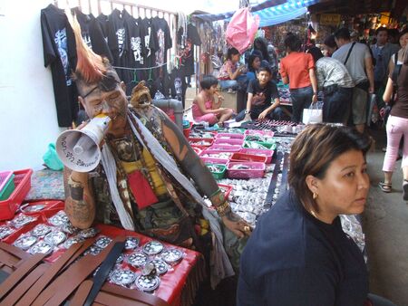 BANGKOK, THAILAND - JANUARY 20 : Thai man and woman advertise their shop in Chatuchak market January 20 2006 in Bangkok. のeditorial素材