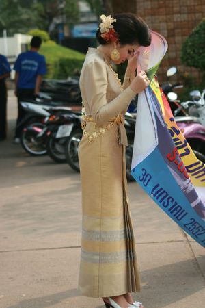 BANGKOK, THAILAND - JANUARY 30: Thai woman dressed in traditional Thai dress directs people into the sports hall of Rangsit university for sports day. January 30 2009 in Bangkok. のeditorial素材