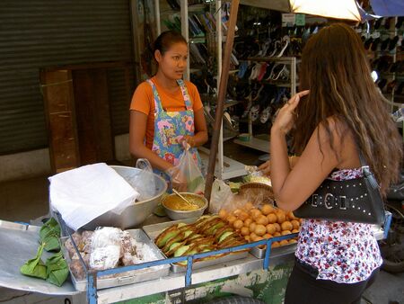 PATTAYA, THAILAND - JUNE 2: Thai woman sells Thai snacks in a market on June 2, 2005 in Pattaya. のeditorial素材