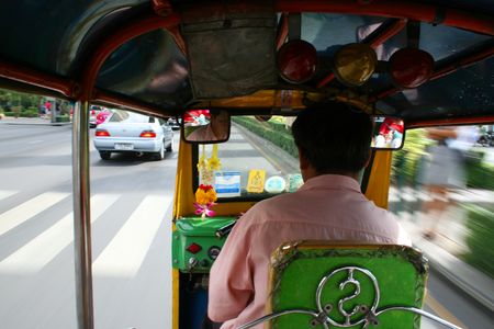 BANGKOK - SEPTEMBER 24: Thai tuk tuk taxi on the road on September 24, 2010 in Bangkok, Thailand. のeditorial素材