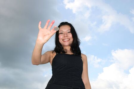 Asian woman under a blue sky.の写真素材