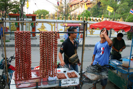 BANGKOK - DECEMBER 20: Thai men sell sausage meat by the side of the road on December 20, 2010 in Bangkok, Thailand. のeditorial素材