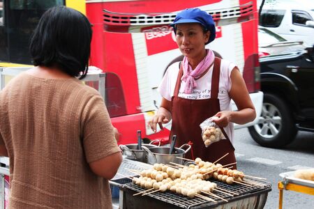 BANGKOK - JUNE 27  People selling food by the roadside in Sukumvit on June 27, 2012 in Bangkok, Thailand のeditorial素材