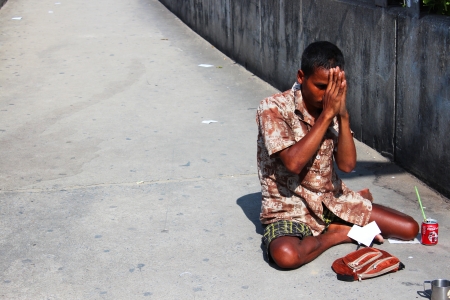 BANGKOK - JULY 24  Thai man begs beside motorway 