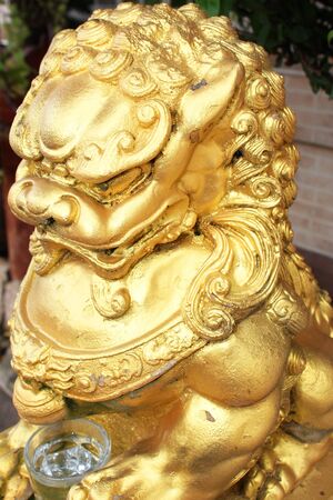 Gold stone lion statue in Thailand の写真素材