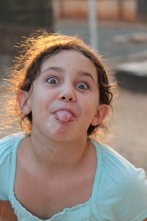 Girl Pulling Faces at Camera, England.の写真素材
