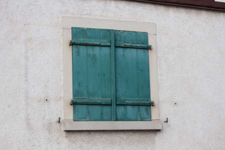 Green Shuttered Window On Traditional House, Germany.